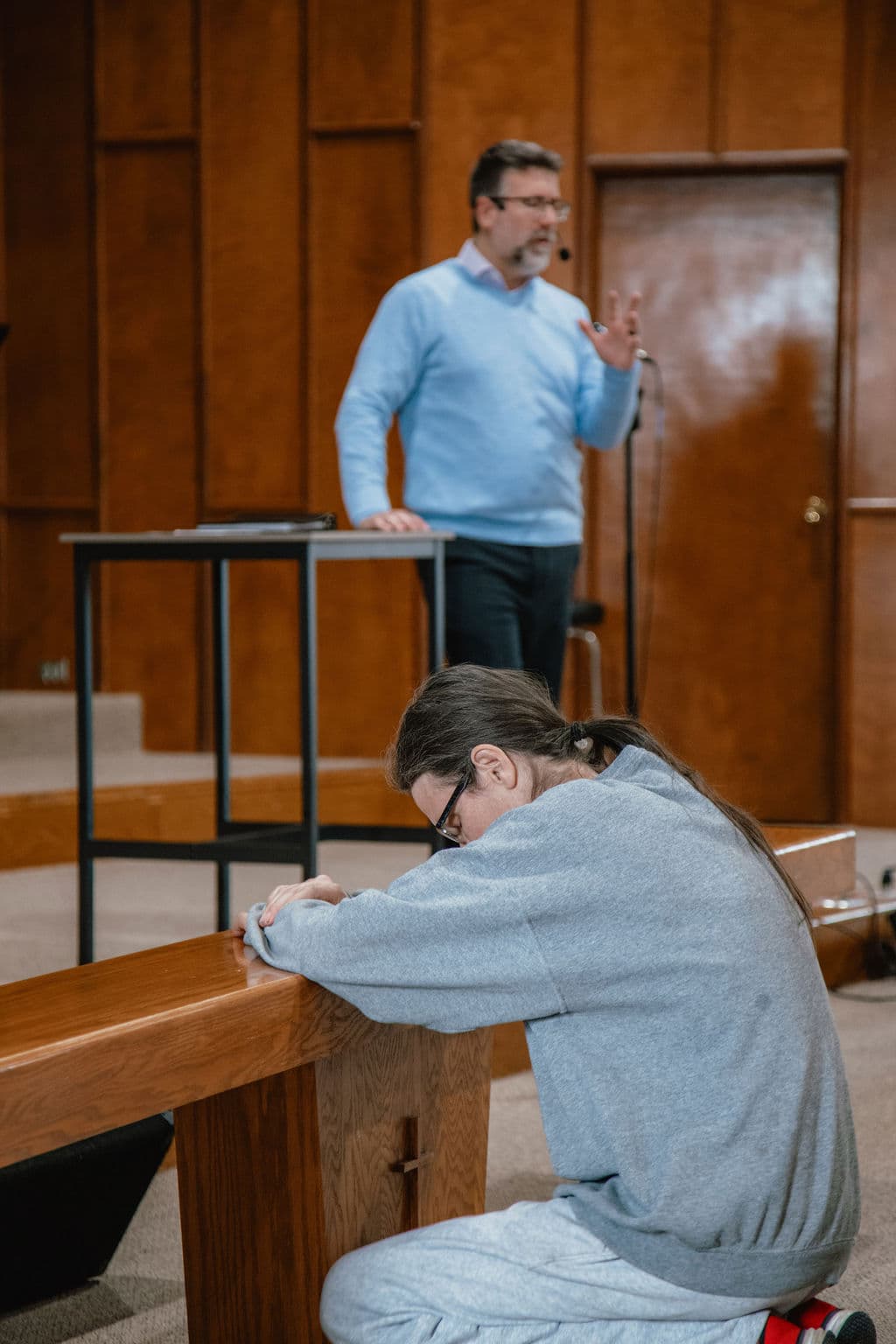 A church member in prayer during worship
